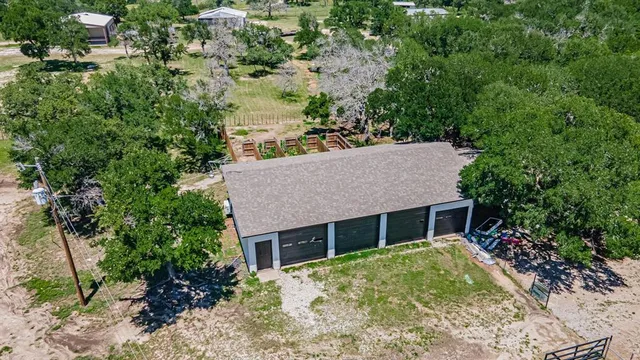 a view of a backyard with large trees