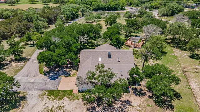 an aerial view of a house with a yard and outdoor seating