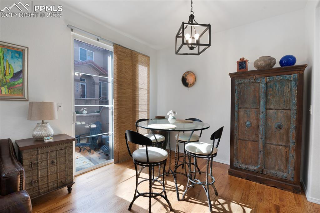 3294 Apogee View Colorado Springs, CO 80906 - Photo 11 of 35 a view of a dining room with furniture and chandelier