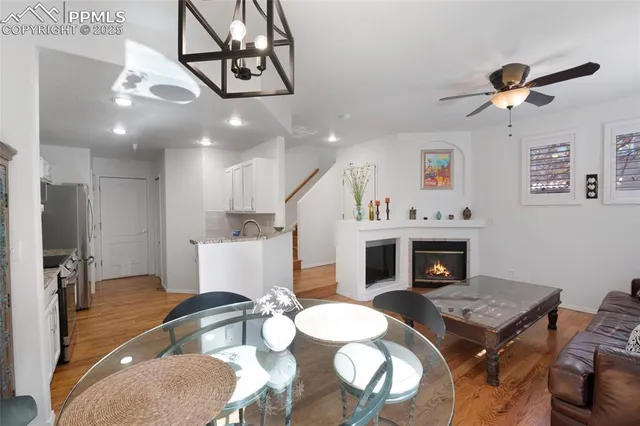 a living room with furniture a fireplace and a chandelier