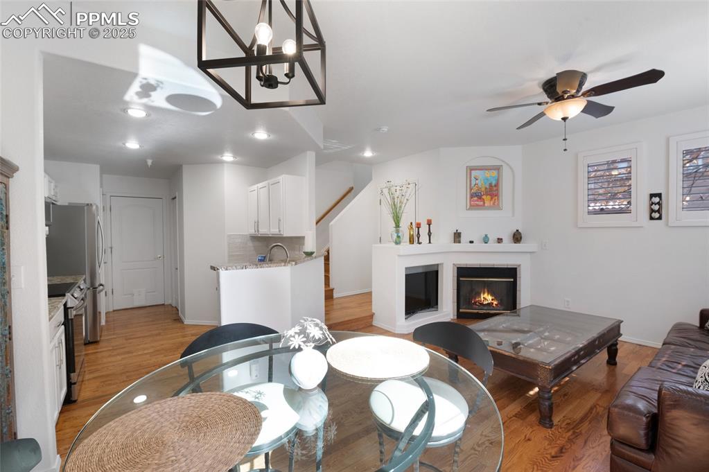 3294 Apogee View Colorado Springs, CO 80906 - Photo 12 of 35 a living room with furniture a fireplace and a chandelier