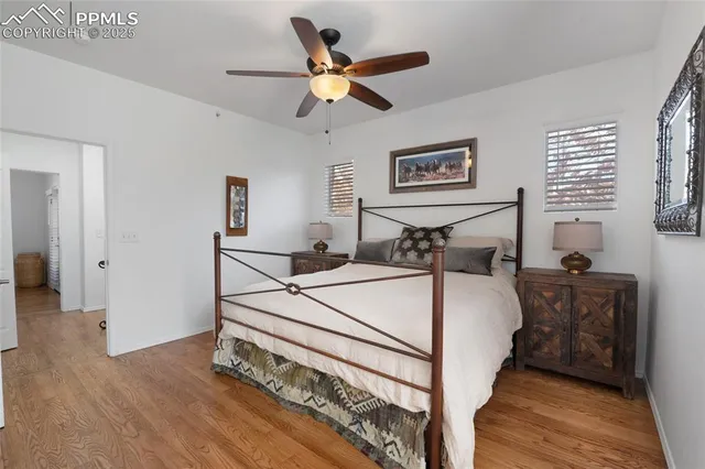 a bed room with a bed and a ceiling fan