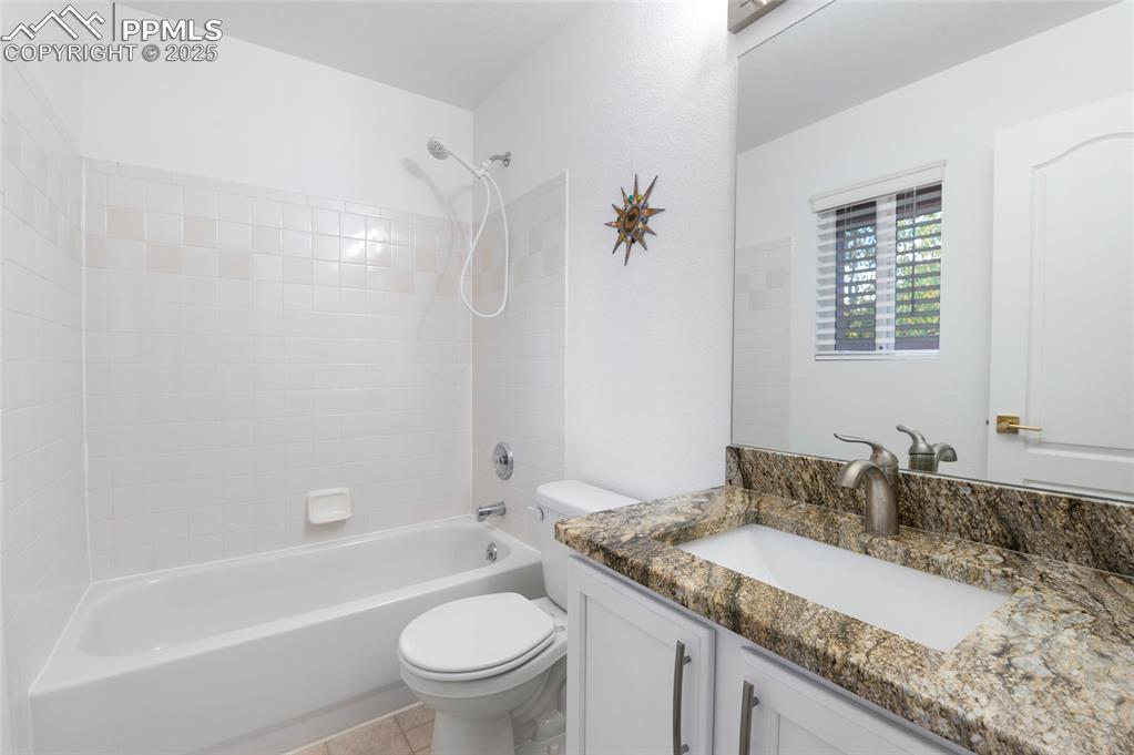 3294 Apogee View Colorado Springs, CO 80906 - Photo 21 of 35 a bathroom with a granite countertop sink toilet and shower
