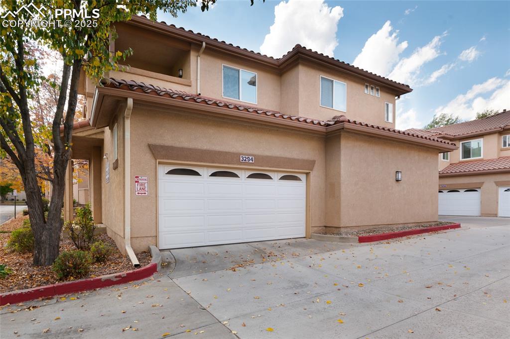 3294 Apogee View Colorado Springs, CO 80906 - Photo 25 of 35 a front view of a house with a yard and garage