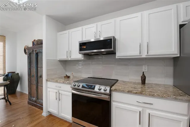 a kitchen with a stove and a microwave