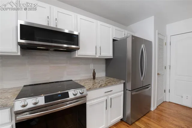 a kitchen with stainless steel appliances a refrigerator stove and microwave