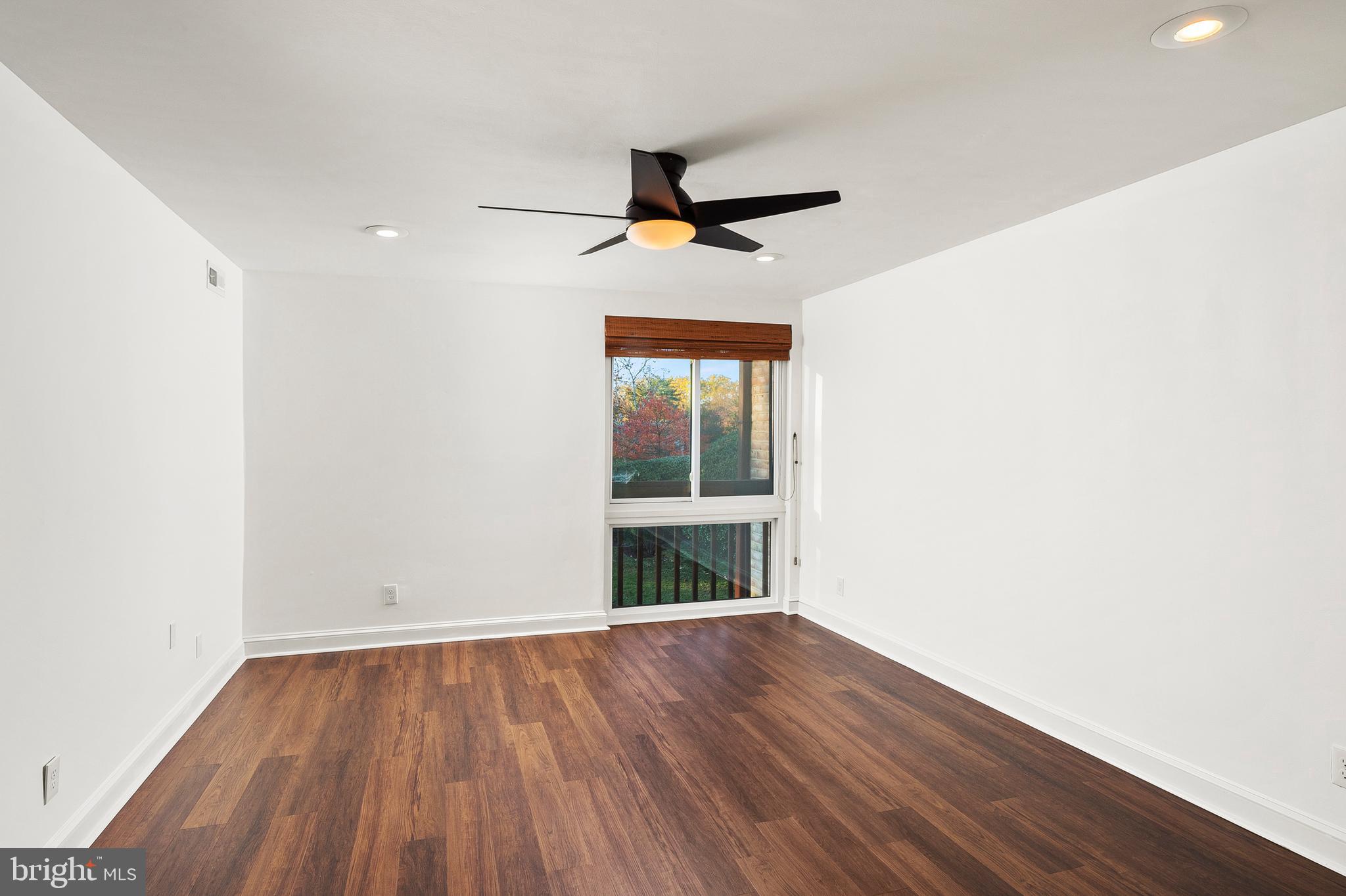 755 Fairview Avenue, Unit 755D Annapolis, MD 21403 - Photo 11 of 44 an empty room with wooden floor fan and windows