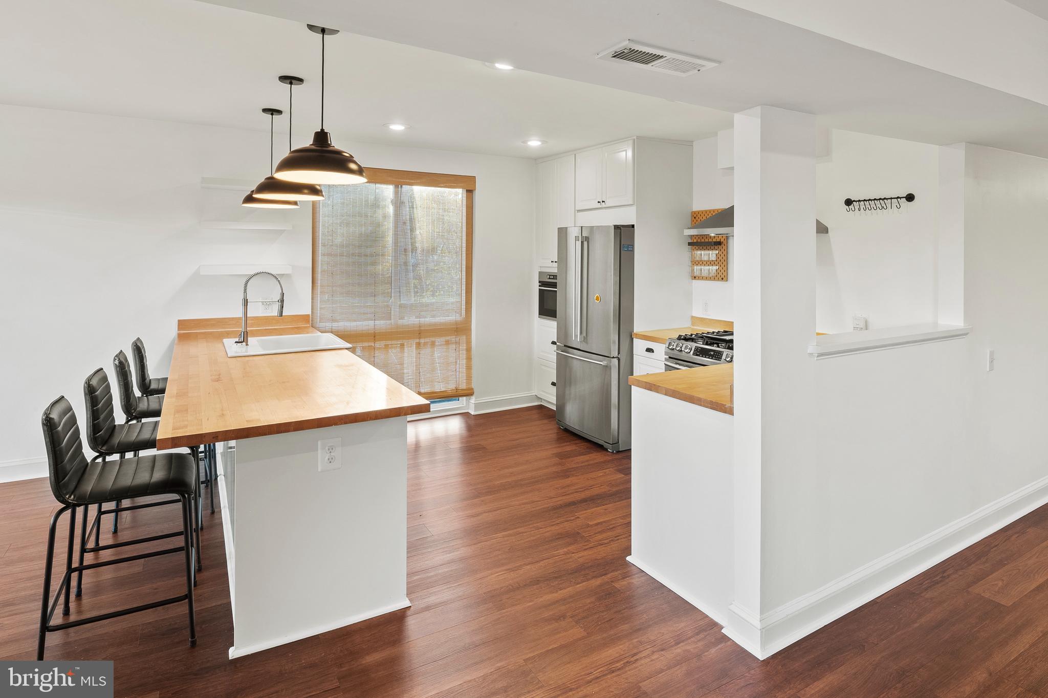 755 Fairview Avenue, Unit 755D Annapolis, MD 21403 - Photo 4 of 44 a kitchen with stainless steel appliances kitchen island a refrigerator and a stove top oven