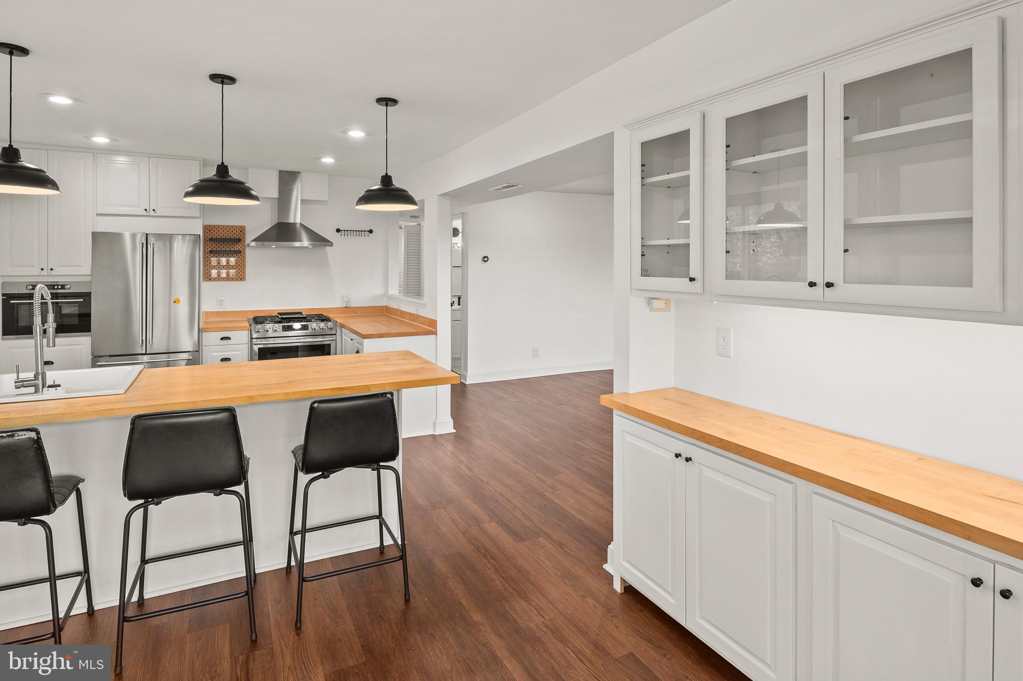 755 Fairview Avenue, Unit 755D Annapolis, MD 21403 - Photo 6 of 44 a kitchen with a table chairs refrigerator and cabinets