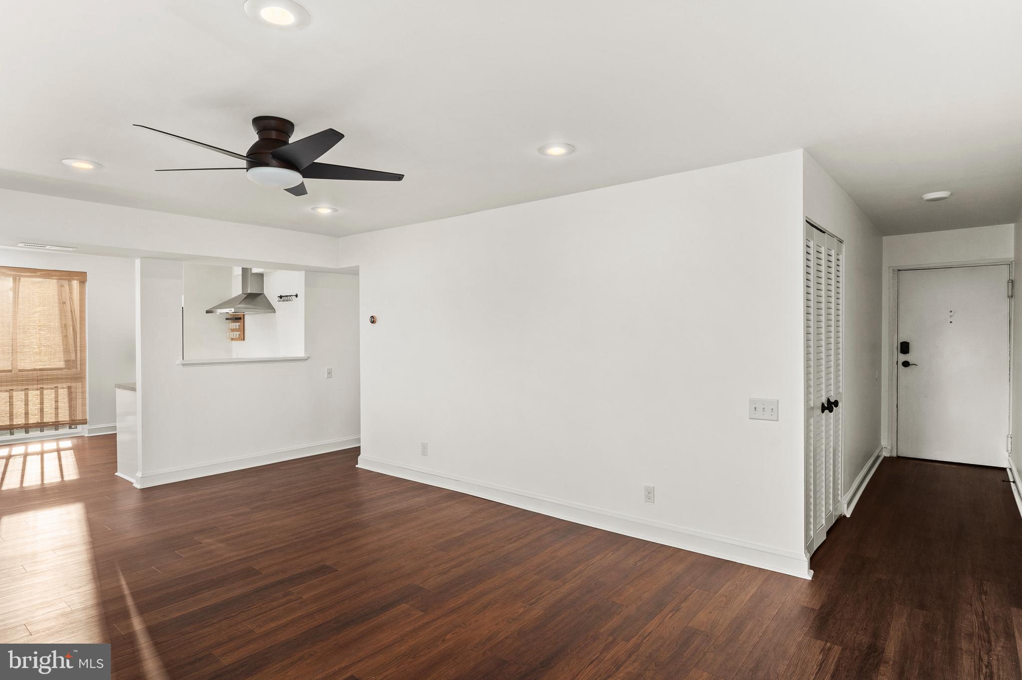 755 Fairview Avenue, Unit 755D Annapolis, MD 21403 - Photo 8 of 44 a view of an empty room with wooden floor and a ceiling fan