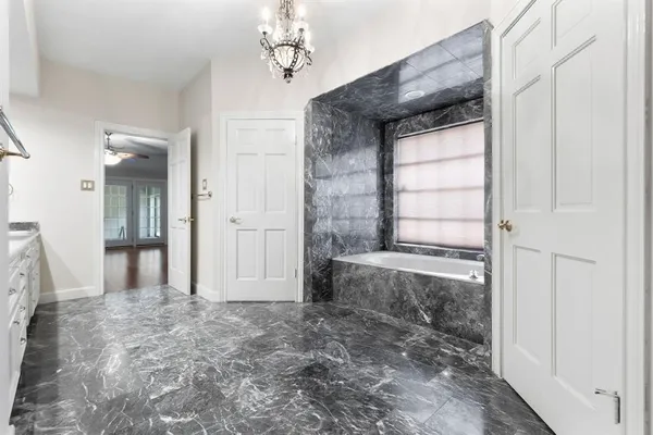a view of a bathroom with a bathtub and shower