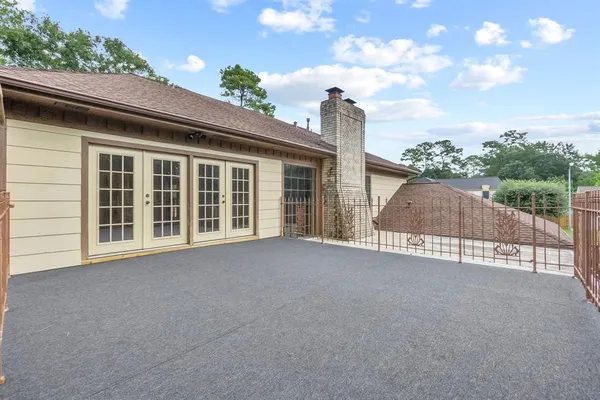 a view of a house with a garden and pathway