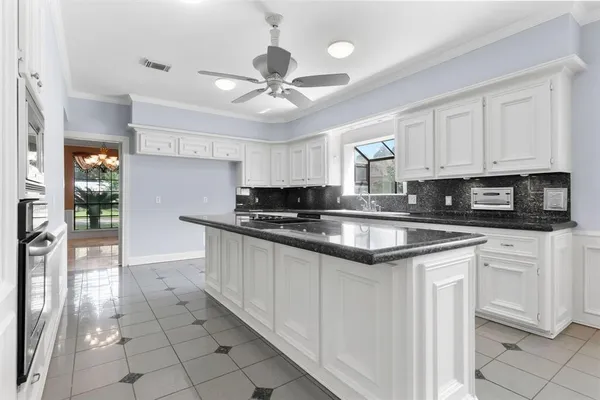 a kitchen with stainless steel appliances granite countertop a stove sink and cabinets