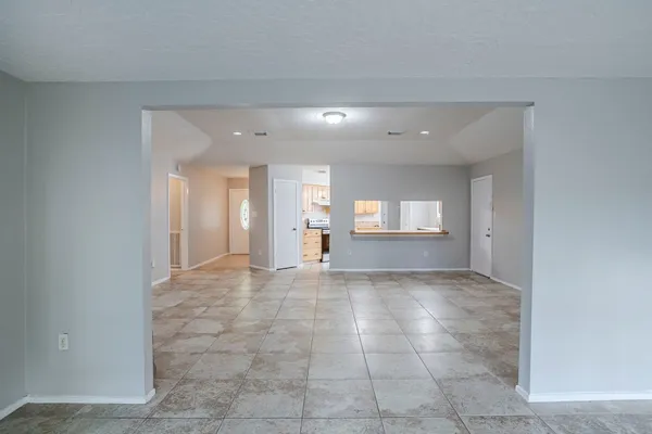a view of an empty room and a window