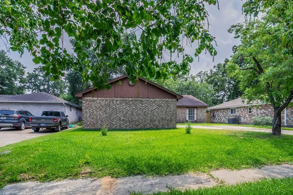 a view of a house with a yard and sitting area