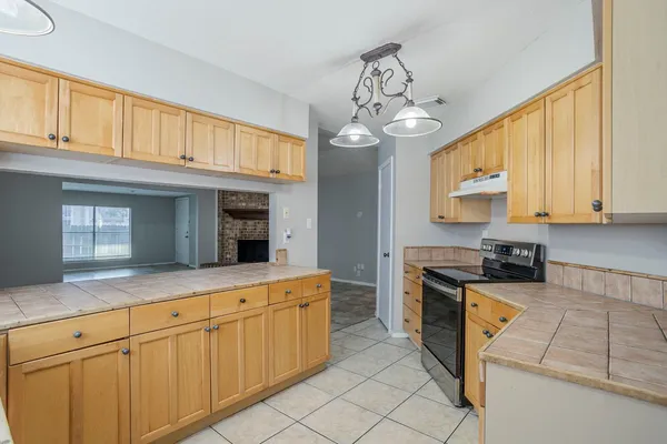 a kitchen with stainless steel appliances granite countertop a stove sink and cabinets