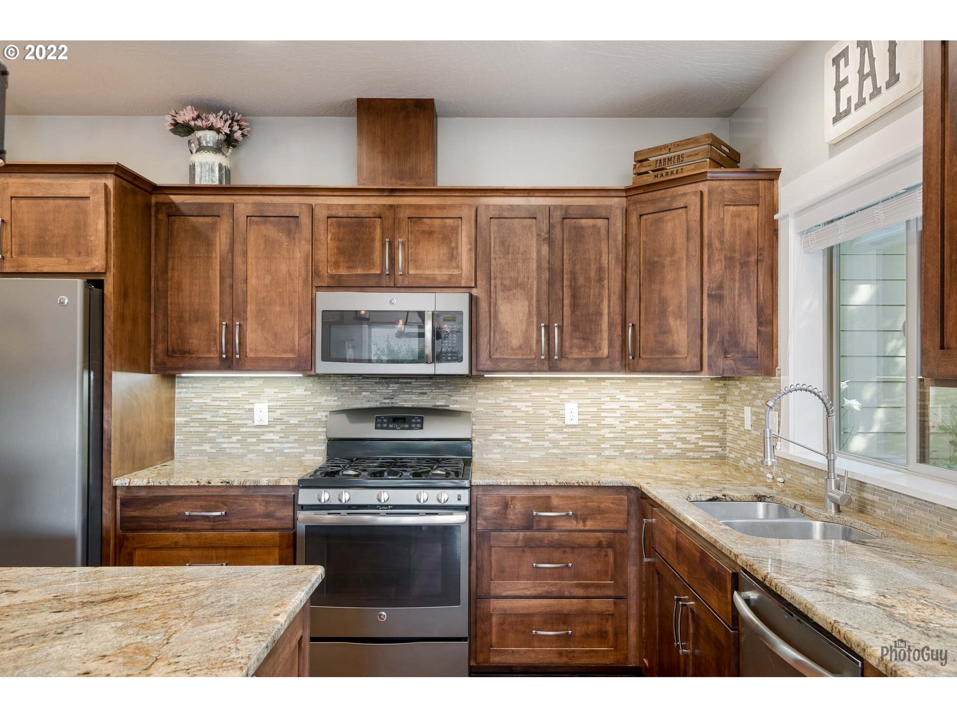 853 67th Place Springfield, OR 97478 - Photo 11 of 32 a kitchen with stainless steel appliances granite countertop a sink stove and refrigerator