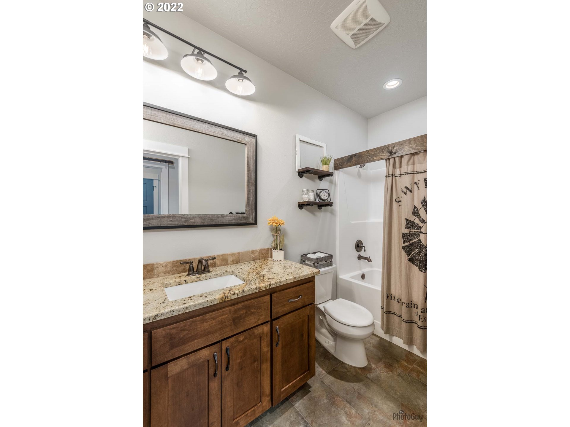 853 67th Place Springfield, OR 97478 - Photo 24 of 32 a bathroom with a granite countertop sink toilet a mirror and shower
