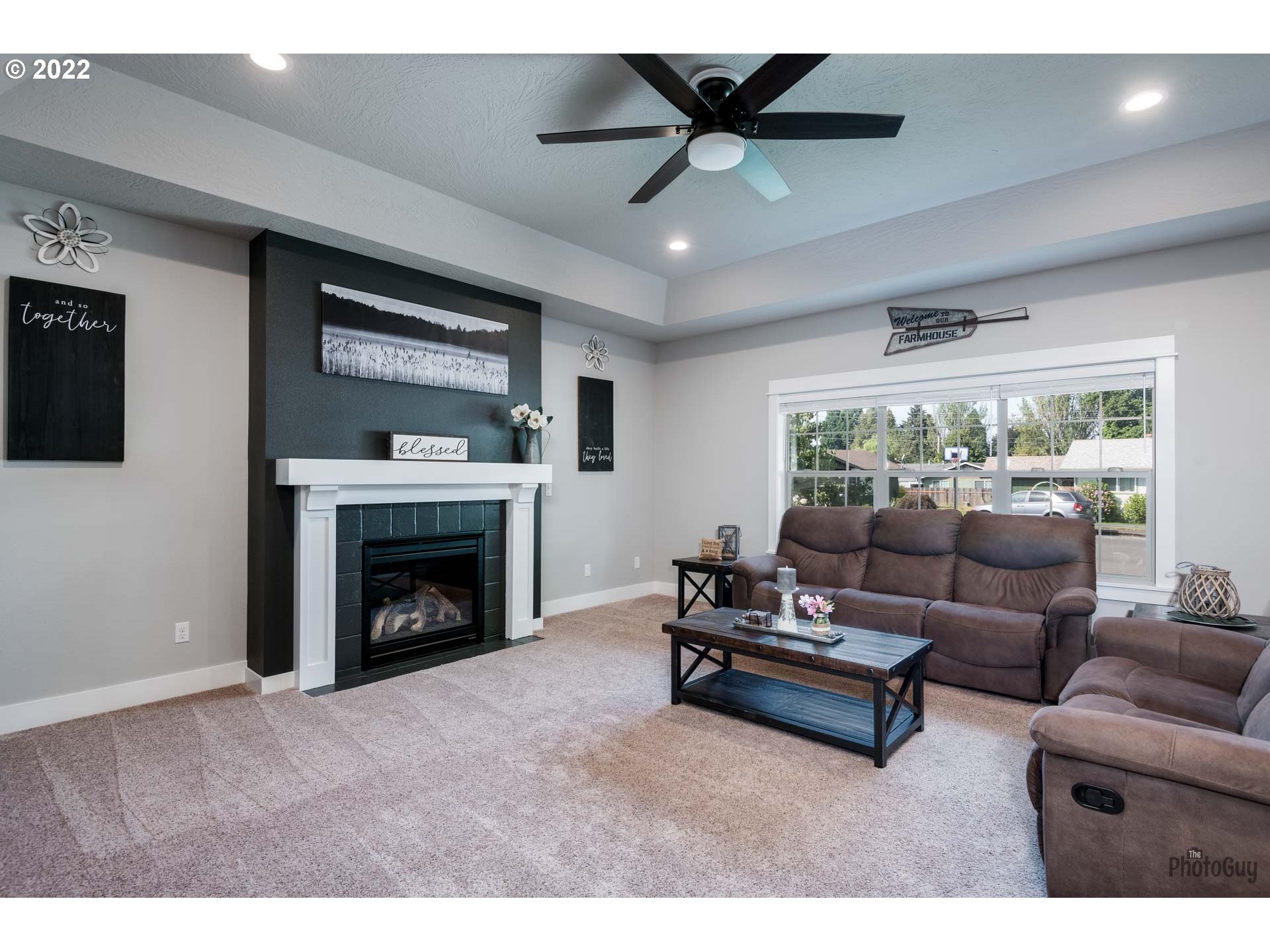 853 67th Place Springfield, OR 97478 - Photo 6 of 32 a living room with furniture a fireplace and a flat screen tv