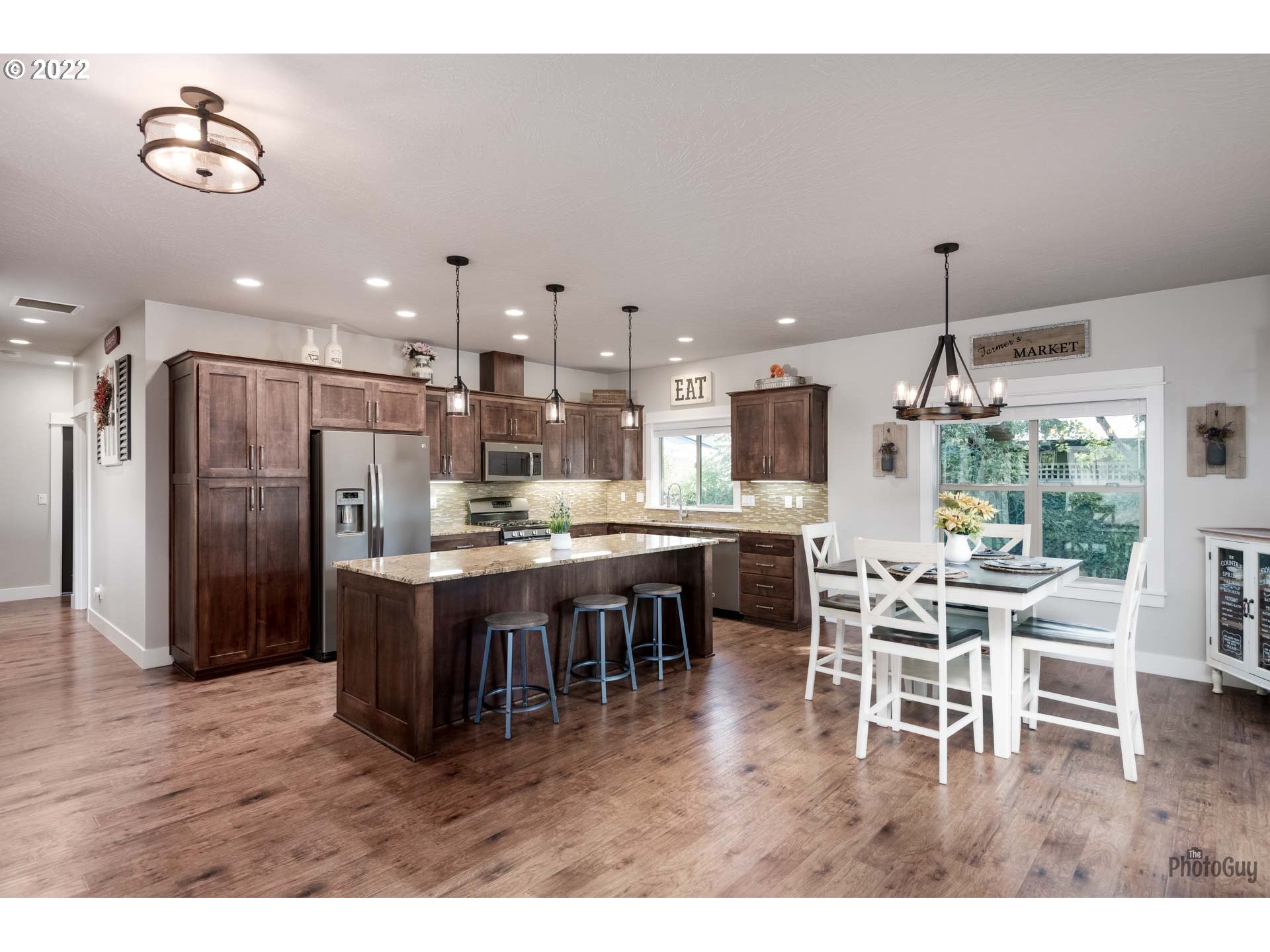 853 67th Place Springfield, OR 97478 - Photo 8 of 32 a dining area with a table chairs and kitchen view
