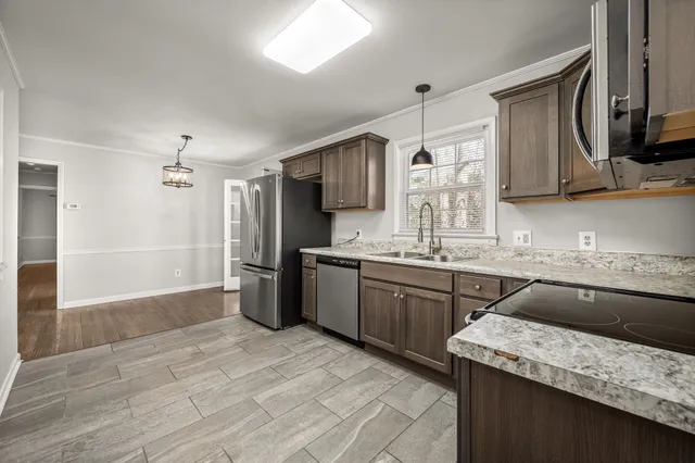a kitchen with a sink stove and refrigerator