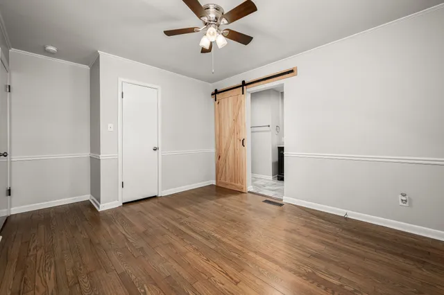 a view of an empty room with wooden floor