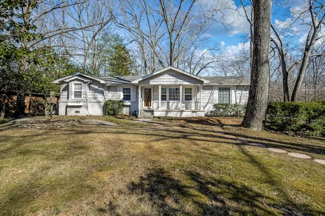 a front view of a house with a garden