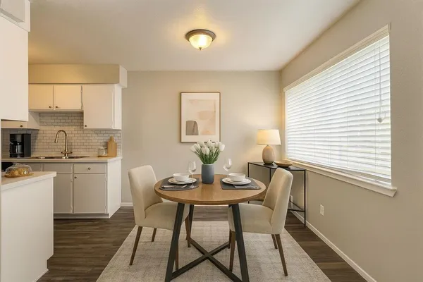 a view of a dining room with furniture and wooden floor