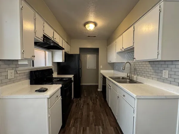 a kitchen with a sink a stove and refrigerator