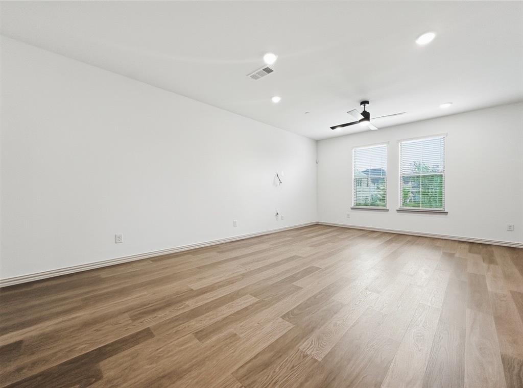 2837 Bluejack Road McKinney, TX 75071 - Photo 6 of 40 an empty room with wooden floor and windows