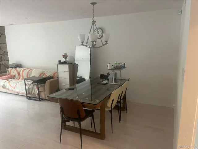 a bathroom with a sink and mirror with bathtub