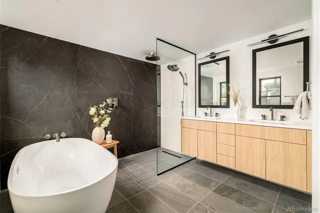 a spacious bathroom with a double vanity sink and a mirror