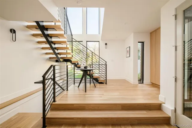 a view of entryway and hall with wooden floor