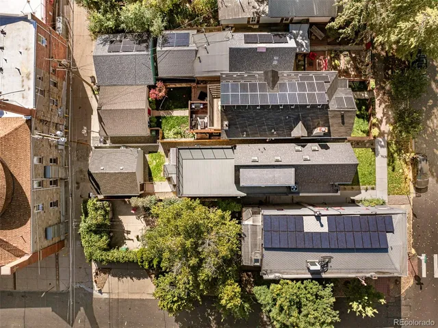 an aerial view of residential houses with outdoor space