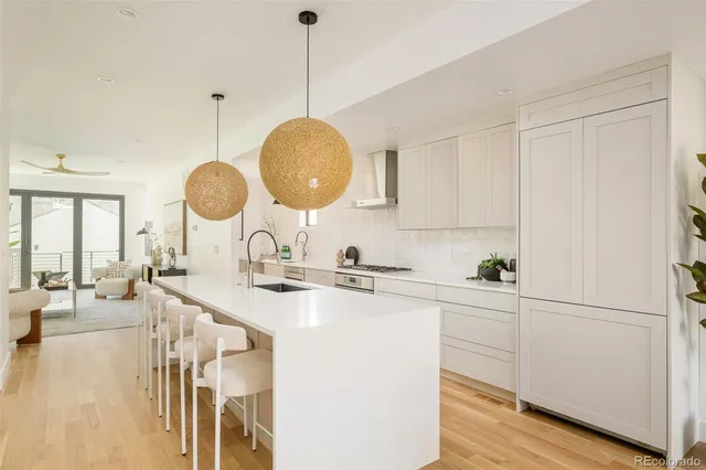 a kitchen with a sink cabinets and wooden floor