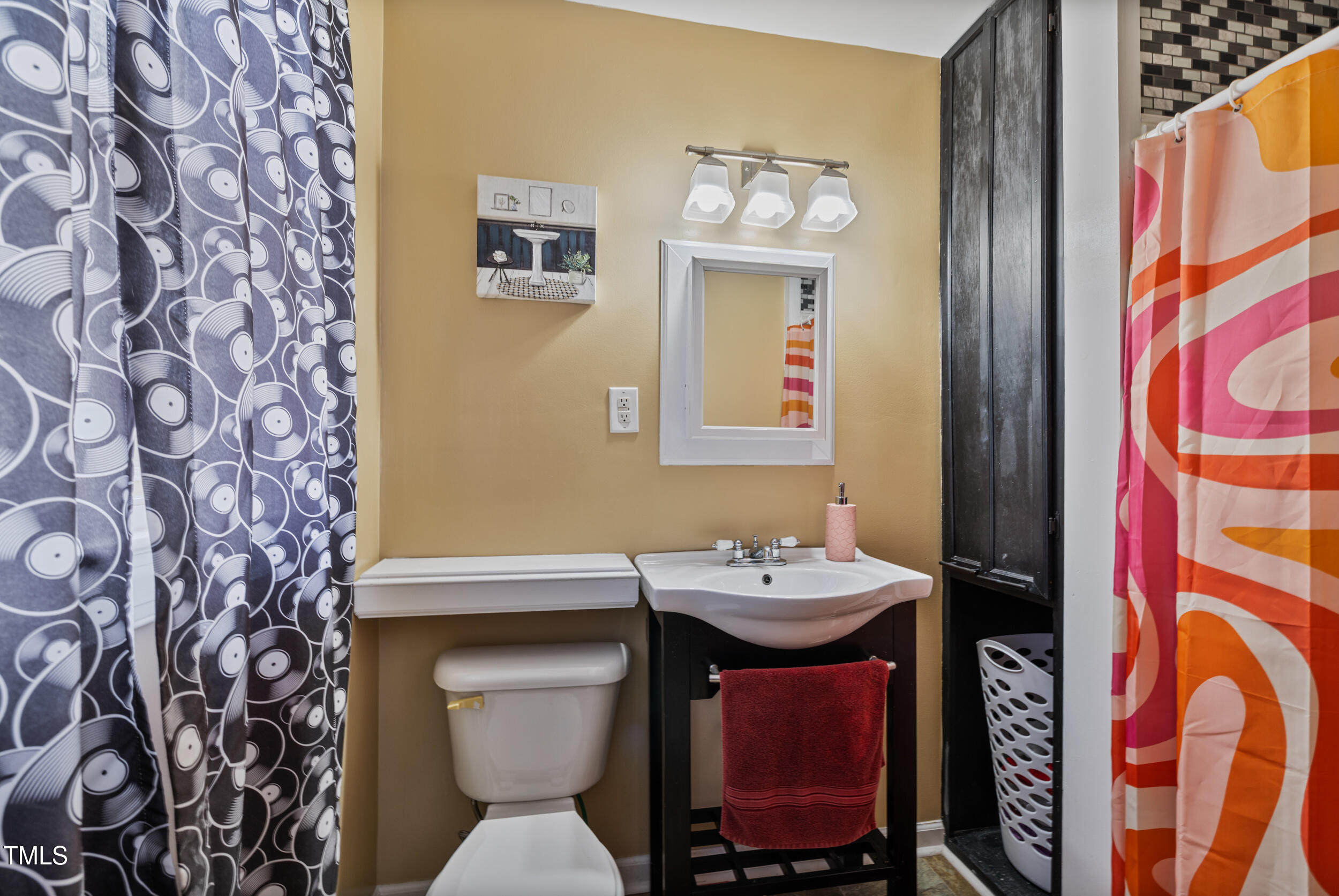 7155 Old Fairground Road Benson, NC 27504 - Photo 16 of 25 a bathroom with a sink a toilet and mirror