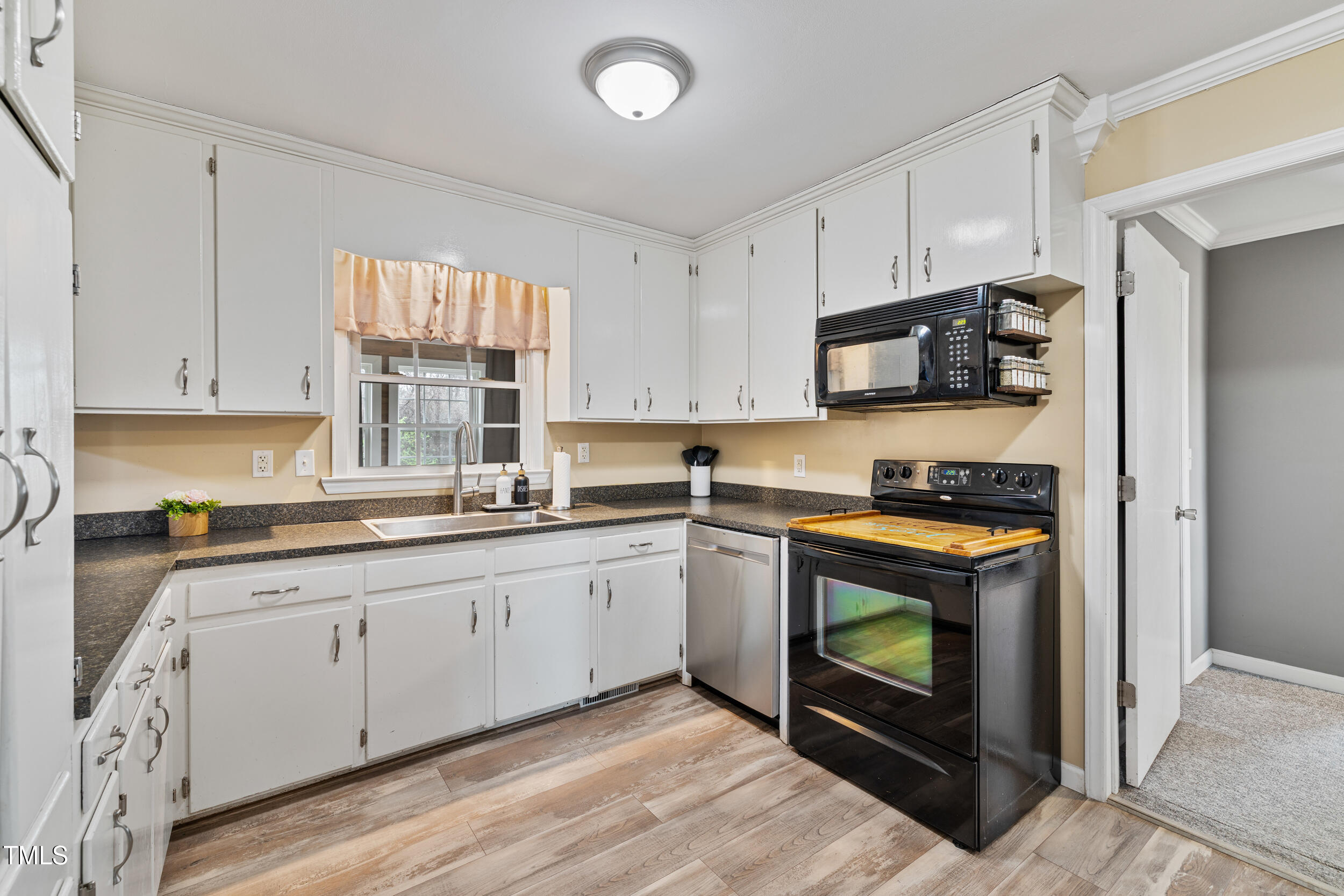 7155 Old Fairground Road Benson, NC 27504 - Photo 5 of 25 a kitchen with stainless steel appliances granite countertop a stove a sink and a microwave
