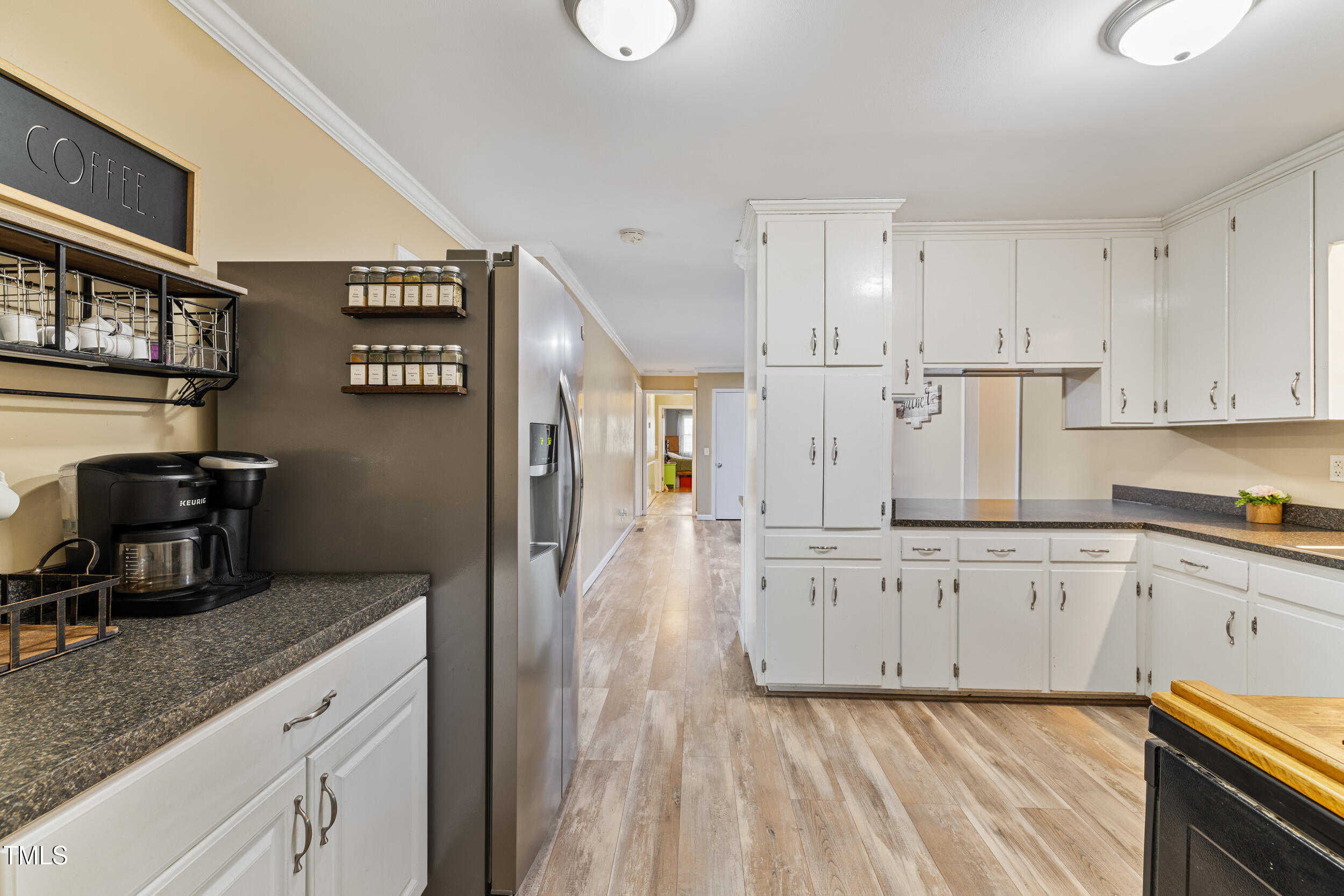 7155 Old Fairground Road Benson, NC 27504 - Photo 6 of 25 a kitchen with granite countertop white cabinets and refrigerator