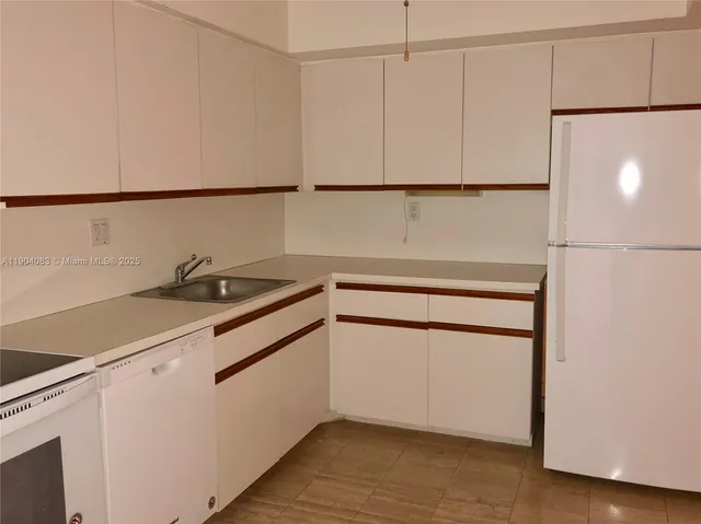 a kitchen with a sink and a refrigerator