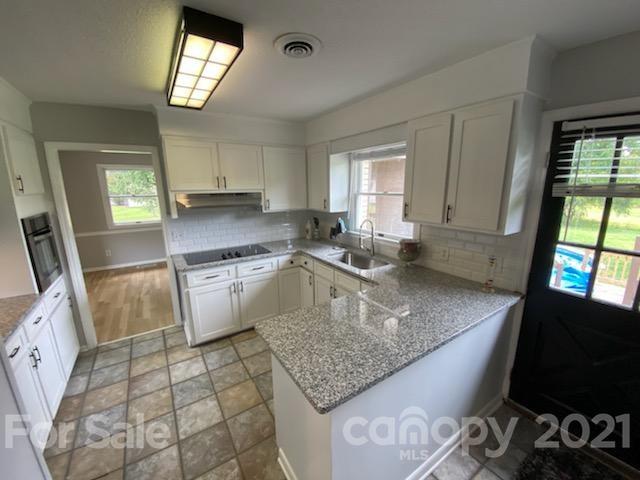 4270 Garmon Mill Road Midland, NC 28107 - Photo 2 of 37 a kitchen with a sink a stove a microwave and cabinets