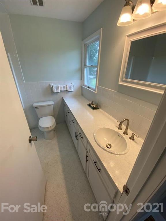 4270 Garmon Mill Road Midland, NC 28107 - Photo 11 of 37 a bathroom with a granite countertop sink mirror vanity and toilet