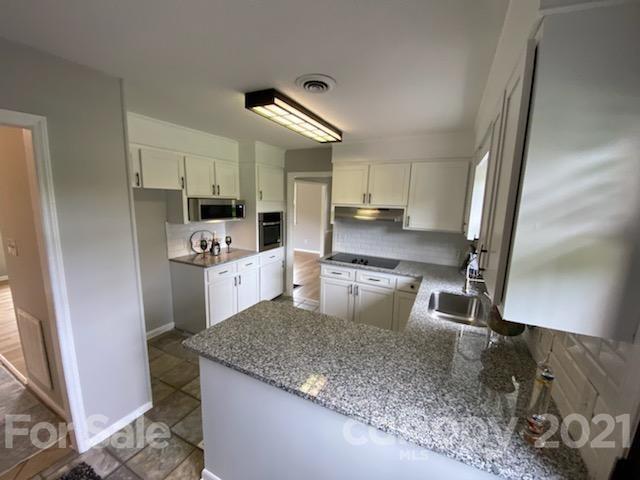 4270 Garmon Mill Road Midland, NC 28107 - Photo 3 of 37 a kitchen with kitchen island granite countertop a sink appliances and cabinets