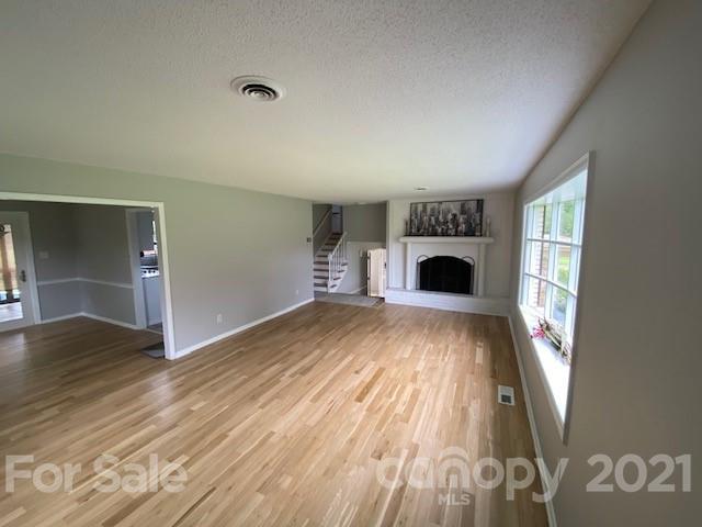 4270 Garmon Mill Road Midland, NC 28107 - Photo 22 of 37 wooden floor in an empty room with a fireplace