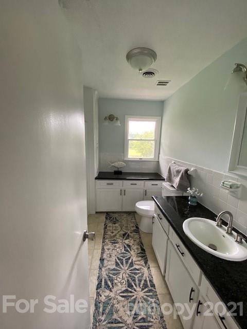 4270 Garmon Mill Road Midland, NC 28107 - Photo 27 of 37 a bathroom with a sink and a mirror
