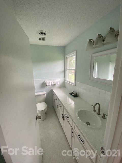 4270 Garmon Mill Road Midland, NC 28107 - Photo 32 of 37 a bathroom with a granite countertop sink mirror and toilet