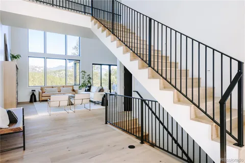 a view of staircase with wooden floor and a large window