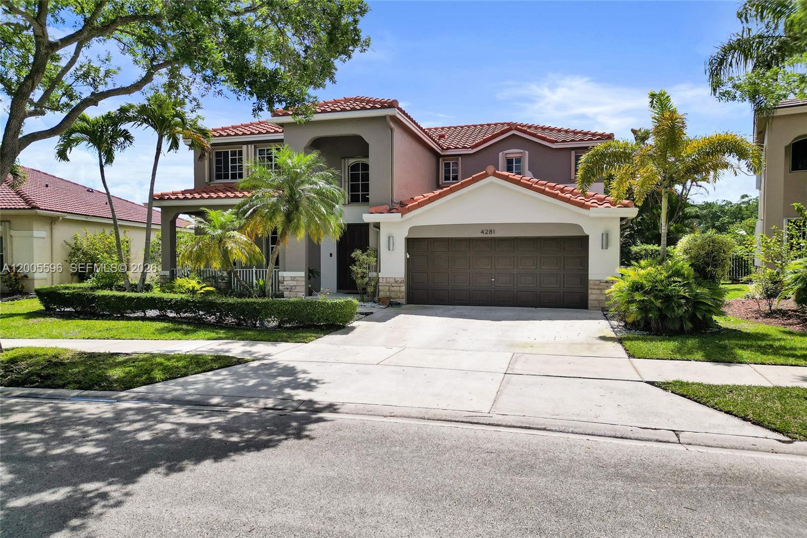 4281 Laurel Ridge Circle Weston, FL 33331 - Photo 2 of 80 a front view of a house with a yard and garage