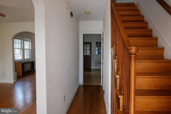 a view of a hallway with wooden floor and entryway