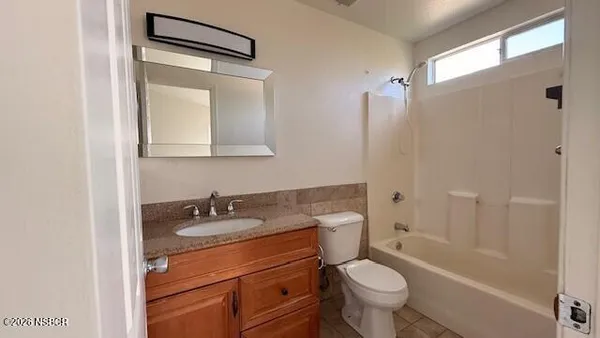 a bathroom with a sink toilet vanity and shower
