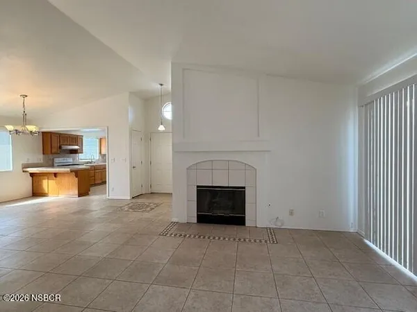 a view of a kitchen with a sink and a fireplace